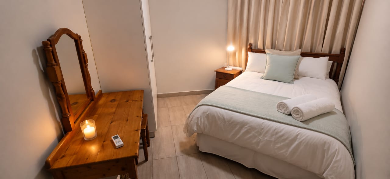 Second bedroom with dresser and mirror